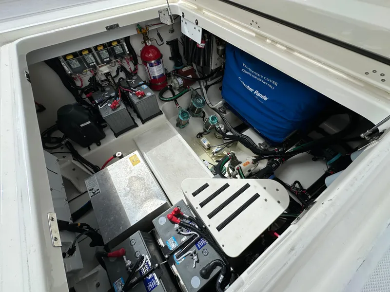 Slide: The Image of 2020 Boston Whaler 420 Outrage engine compartment with batteries and equipment. - 17