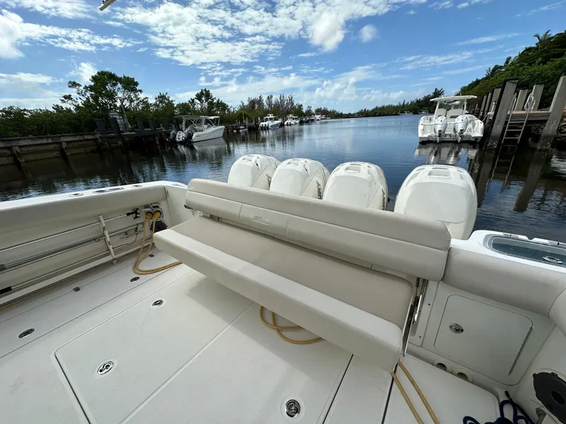 Slide: The Image of 2020 Boston Whaler 420 Outrage boat with multiple engines docked on a sunny day. - 20