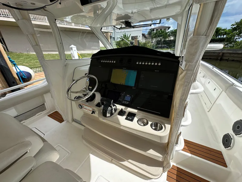 Slide: The Image of 2020 Boston Whaler 420 Outrage helm with advanced navigation system and luxurious seating. - 24