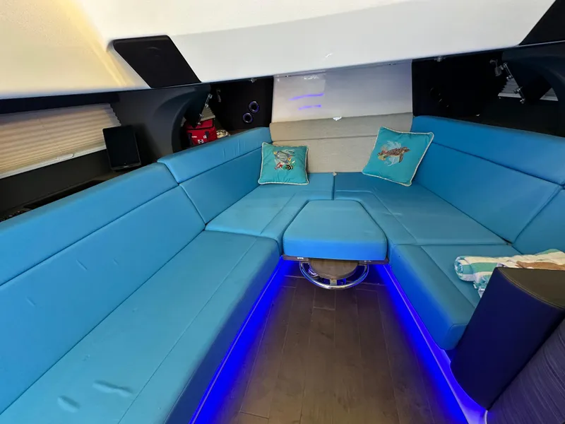 Slide: The Image of Luxurious interior of 2020 Boston Whaler 420 Outrage with blue seating and ambient lighting. - 28