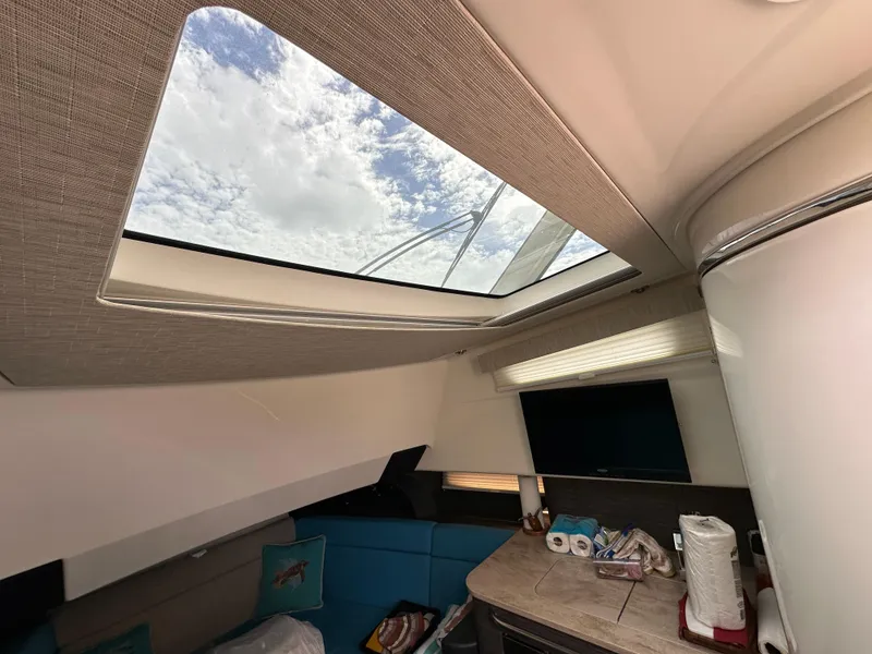 Slide: The Image of Interior of 2020 Boston Whaler 420 Outrage with skylight and modern amenities. - 29