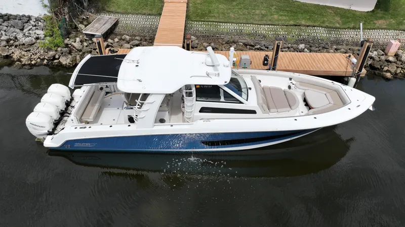 Slide: The Image of 2020 Boston Whaler 420 Outrage boat docked on calm water. - 4