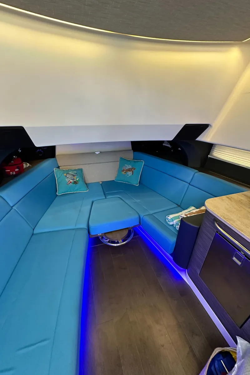 Slide: The Image of Luxurious interior of 2020 Boston Whaler 420 Outrage with blue seating and ambient lighting. - 41