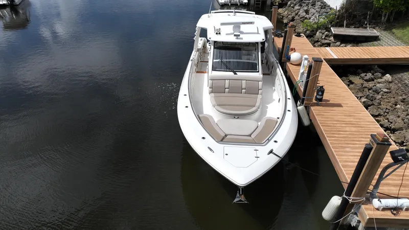 Slide: The Image of Boston Whaler 420 Outrage 2020 docked in calm waters, aerial view. - 5