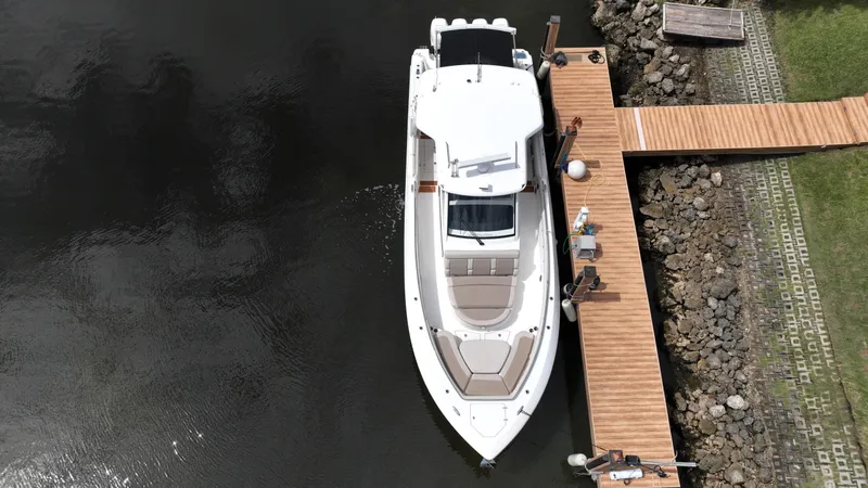 Slide: The Image of Aerial view of 2020 Boston Whaler 420 Outrage docked at a wooden pier. - 6