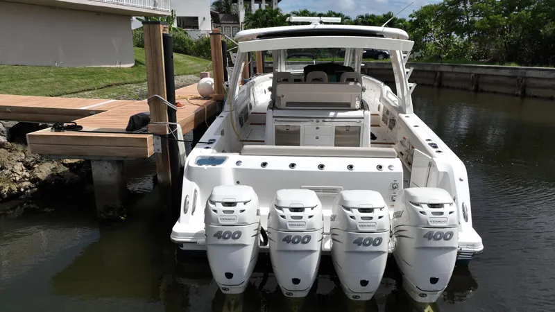 Slide: The Image of 2020 Boston Whaler 420 Outrage with quad 400 engines docked in a marina. - 8