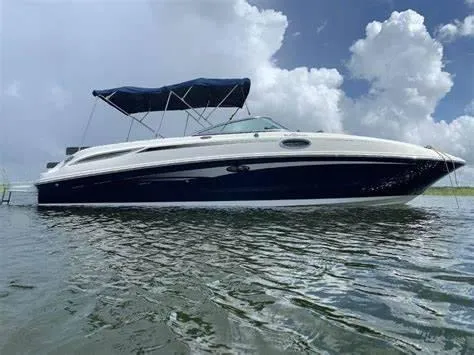 Slide: The Image of 2011 Sea Ray 280 Sundeck boat on water under cloudy sky. - 1