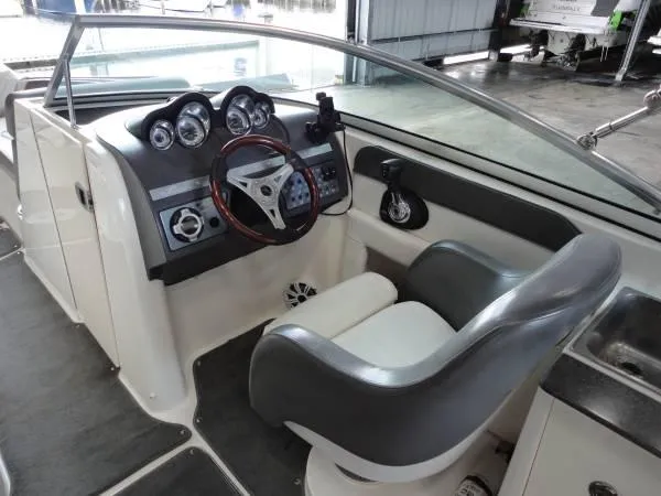 Slide: The Image of 2011 Sea Ray 280 Sundeck cockpit with steering wheel and gauges. - 10