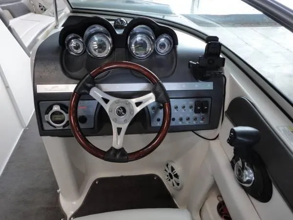 Slide: The Image of 2011 Sea Ray 280 Sundeck dashboard with gauges and steering wheel. - 11