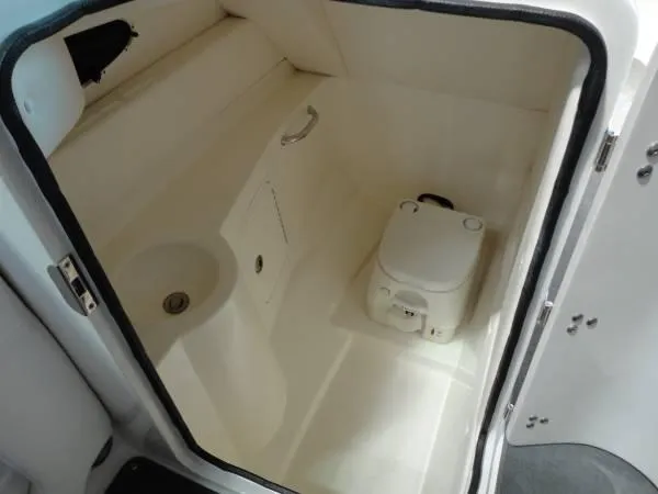 Slide: The Image of 2011 Sea Ray 280 Sundeck boat interior with compact marine toilet. - 13