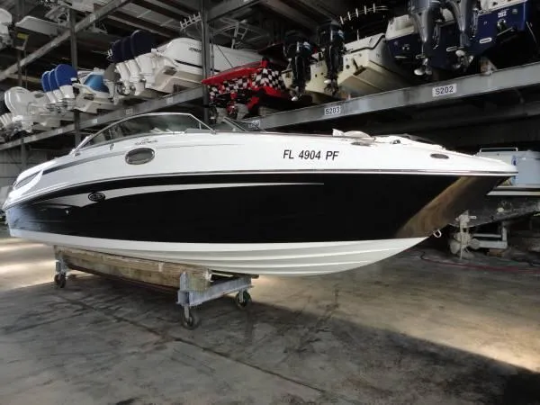Slide: The Image of 2011 Sea Ray 280 Sundeck boat in storage, black and white exterior. - 3