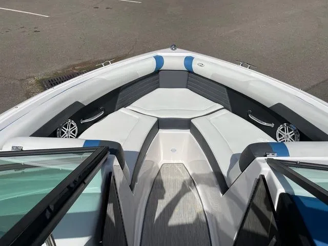 Slide: The Image of 2016 Regal 2100 RX Surf boat interior with cushioned seating and speakers. - 5