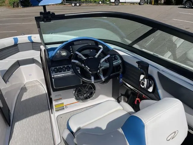 Slide: The Image of 2016 Regal 2100 RX Surf boat interior with steering wheel and seating. - 6