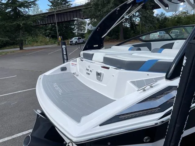 Slide: The Image of 2016 Regal 2100 RX Surf boat in parking lot, rear view. - 7