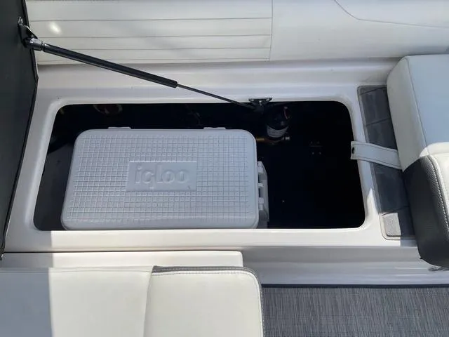 Slide: The Image of 2016 Regal 2100 RX Surf boat storage compartment with Igloo cooler. - 8