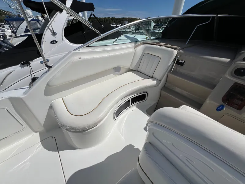 Slide: The Image of 2001 Sea Ray 270 Sundancer boat interior with white seating and dashboard. - 13