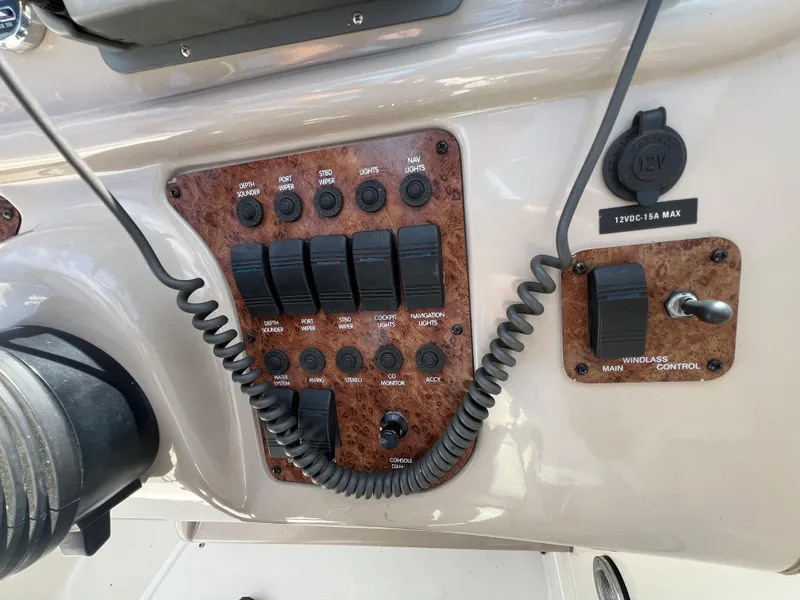Slide: The Image of Control panel of a 2001 Sea Ray 270 Sundancer boat with various switches and dials. - 17