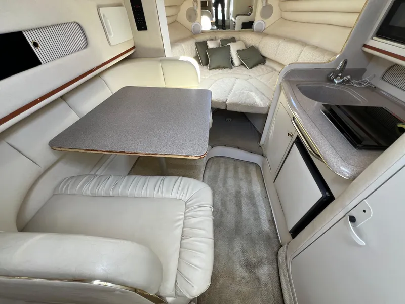 Slide: The Image of Interior of 2001 Sea Ray 270 Sundancer with seating, table, and kitchenette. - 20
