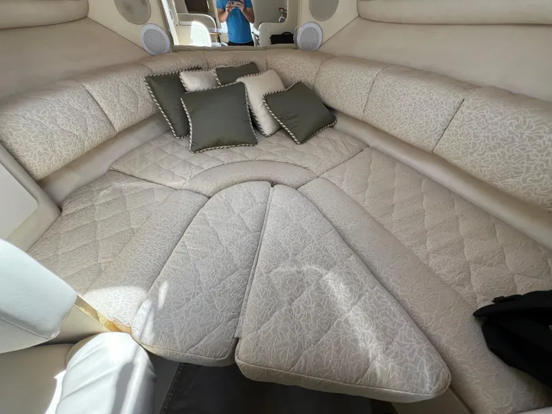 Slide: The Image of Interior cabin of 2001 Sea Ray 270 Sundancer with cushioned seating and pillows. - 21