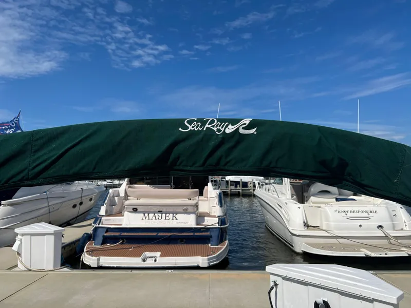Slide: The Image of 2001 Sea Ray 270 Sundancer docked at marina under blue sky. - 31