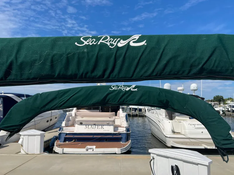 Slide: The Image of Sea Ray 270 Sundancer 2001 at marina, green covers, clear blue sky. - 32