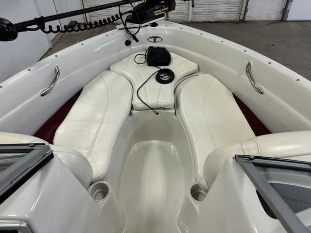 Slide: The Image of 2013 Tahoe Q5i SF boat interior with white seating and fishing equipment. - 16