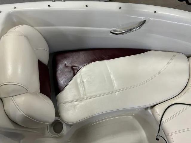 Slide: The Image of 2013 Tahoe Q5i SF boat interior with white and maroon seating. - 17