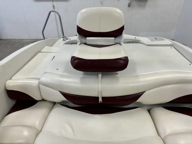 Slide: The Image of 2013 Tahoe Q5i SF boat interior with white and maroon seating. - 20