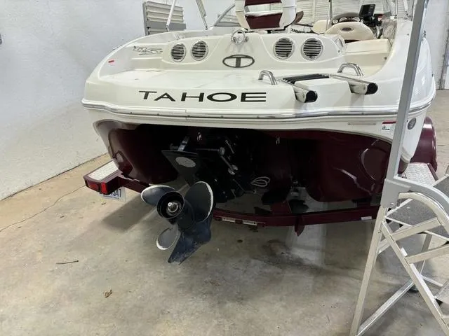 Slide: The Image of 2013 Tahoe Q5i SF boat in garage, rear view with visible propeller. - 25