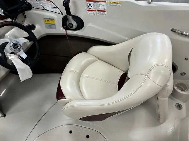 Slide: The Image of 2013 Tahoe Q5i SF boat interior with white leather seat and steering wheel. - 5