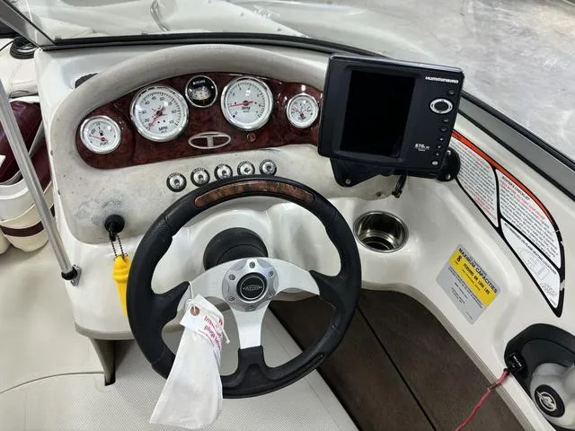 Slide: The Image of 2013 Tahoe Q5i SF boat dashboard with steering wheel and gauges. - 6