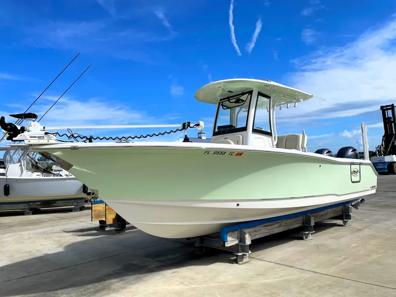 Slide: The Image of 2022 Sea Hunt Gamefish 25 boat on a dock under a clear blue sky. - 1