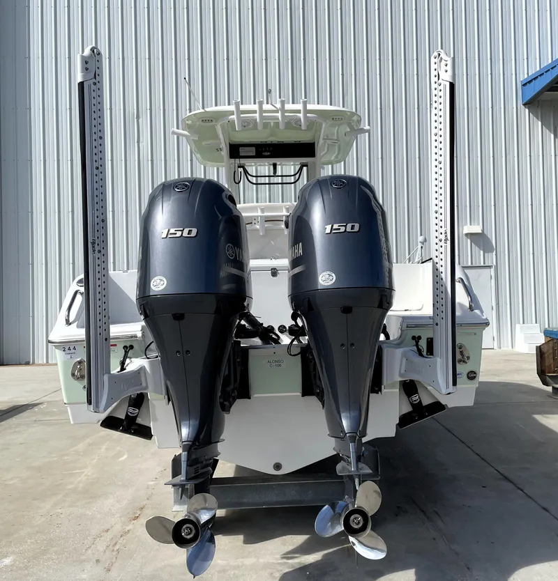 Slide: The Image of 2022 Sea Hunt Gamefish 25 with dual 150 horsepower engines, docked outdoors. - 11