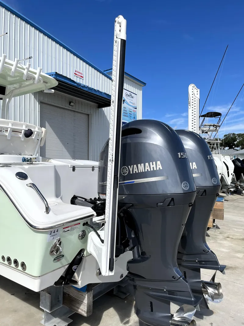 Slide: The Image of 2022 Sea Hunt Gamefish 25 with dual Yamaha 150 engines at a marina. - 12