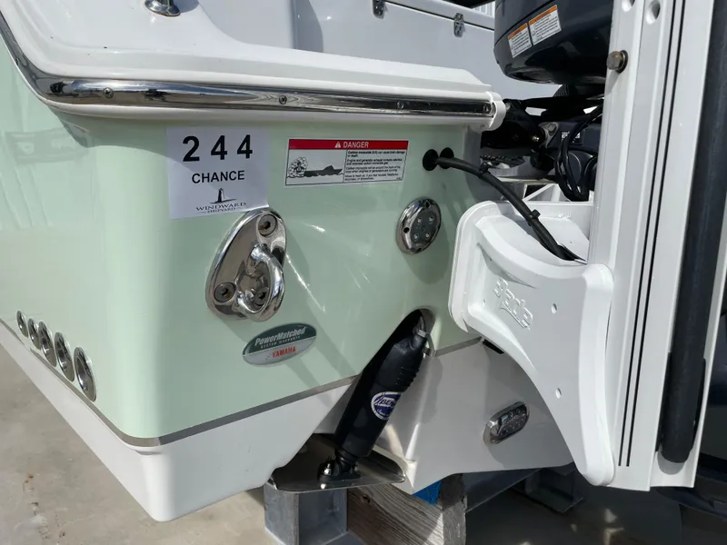 Slide: The Image of 2022 Sea Hunt Gamefish 25 boat stern with motor mount and safety labels. - 16