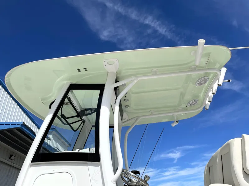 Slide: The Image of 2022 Sea Hunt Gamefish 25 boat with T-top against a clear blue sky. - 18
