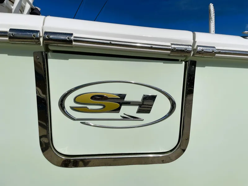 Slide: The Image of 2022 Sea Hunt Gamefish 25 boat logo on side panel, featuring SH emblem. - 19