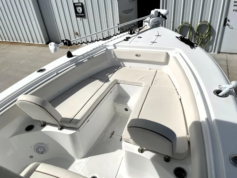Slide: The Image of 2022 Sea Hunt Gamefish 25 boat interior with cushioned seating and fishing equipment. - 21