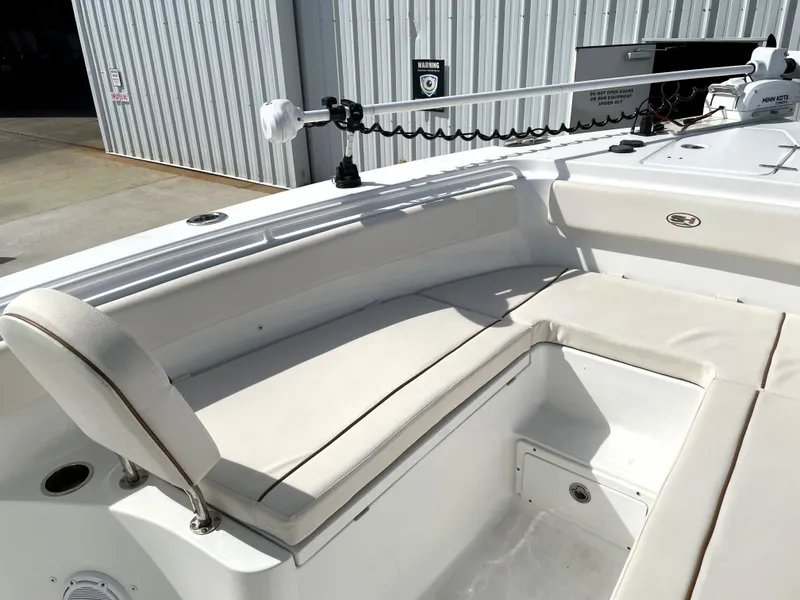 Slide: The Image of 2022 Sea Hunt Gamefish 25 boat interior with cushioned seating and fishing equipment. - 22