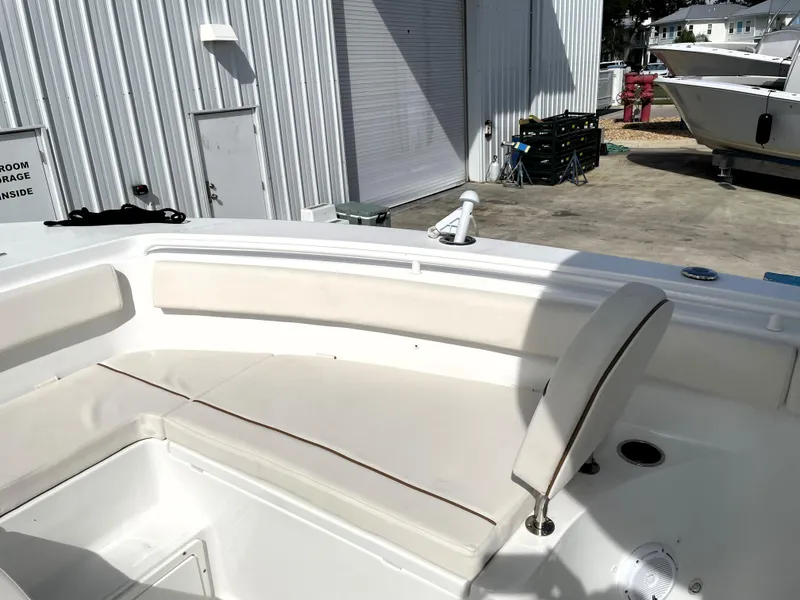 Slide: The Image of 2022 Sea Hunt Gamefish 25 boat interior with white seating and storage area. - 23