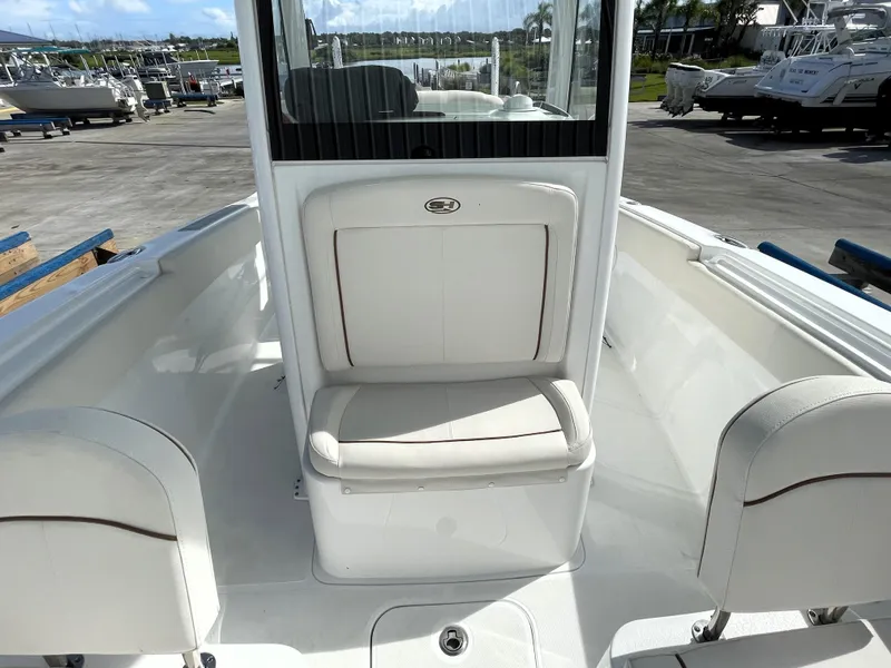Slide: The Image of 2022 Sea Hunt Gamefish 25 boat interior with white seating and console. - 31