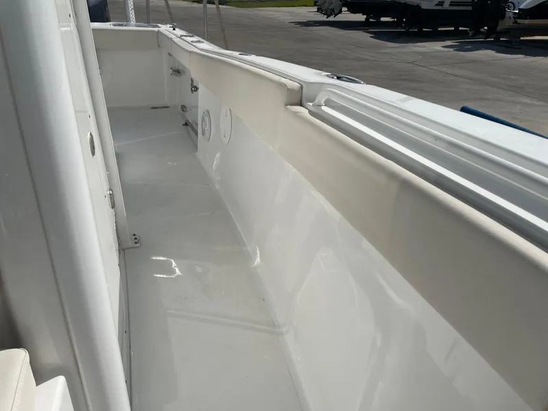 Slide: The Image of 2022 Sea Hunt Gamefish 25 boat interior, showcasing sleek white deck and side paneling. - 34