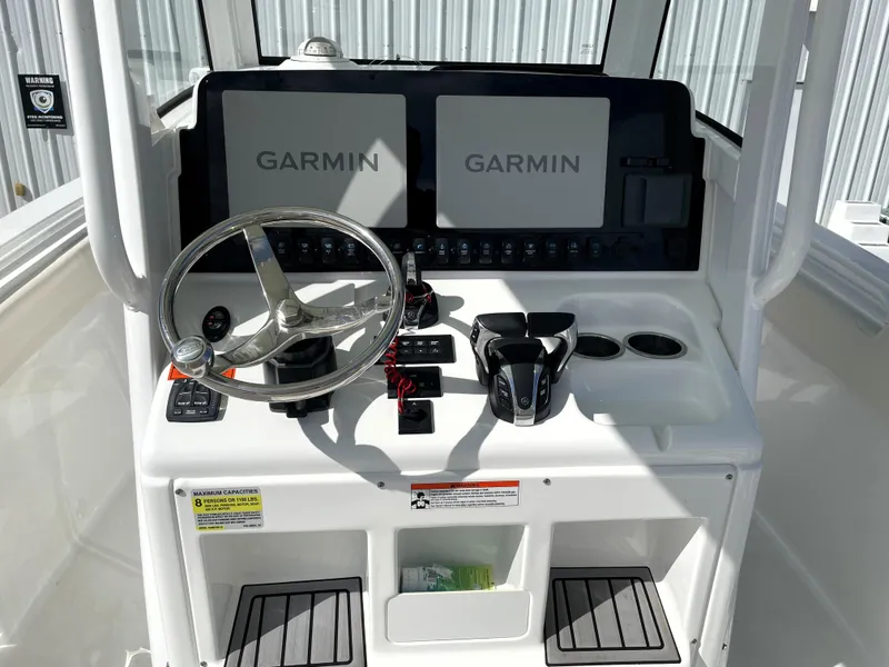 Slide: The Image of 2022 Sea Hunt Gamefish 25 helm with dual Garmin displays and steering wheel. - 37
