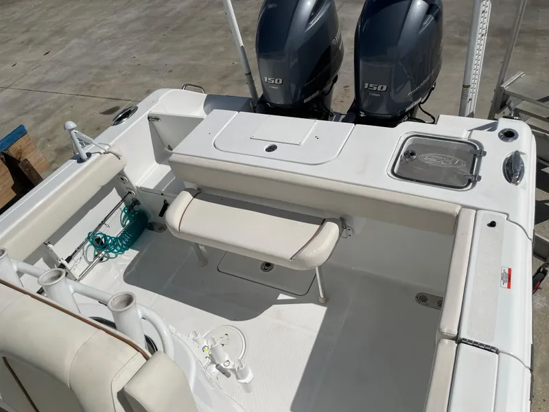 Slide: The Image of 2022 Sea Hunt Gamefish 25 boat interior with dual engines and seating. - 45
