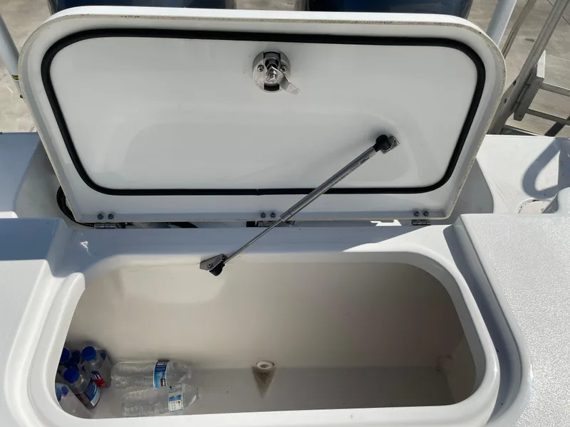 Slide: The Image of Open storage compartment on 2022 Sea Hunt Gamefish 25 boat with water bottles inside. - 49