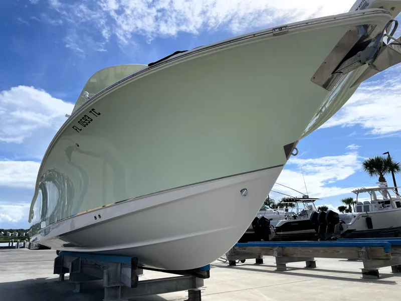 Slide: The Image of 2022 Sea Hunt Gamefish 25 boat on display under a clear blue sky. - 8