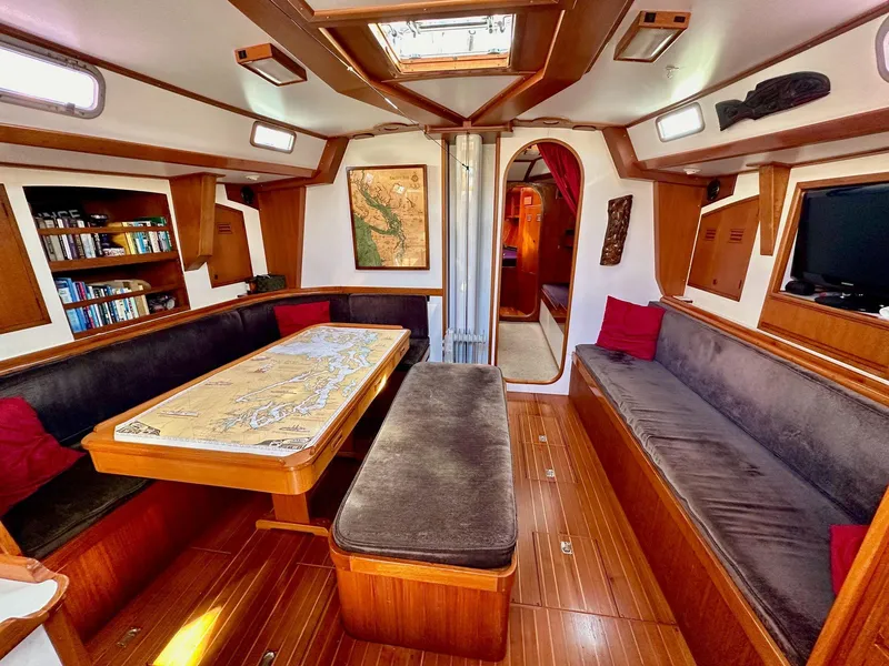 Slide: The Image of Interior of 1986 Cheoy Lee Pedrick 55 Sloop with cozy seating and nautical decor. - 1