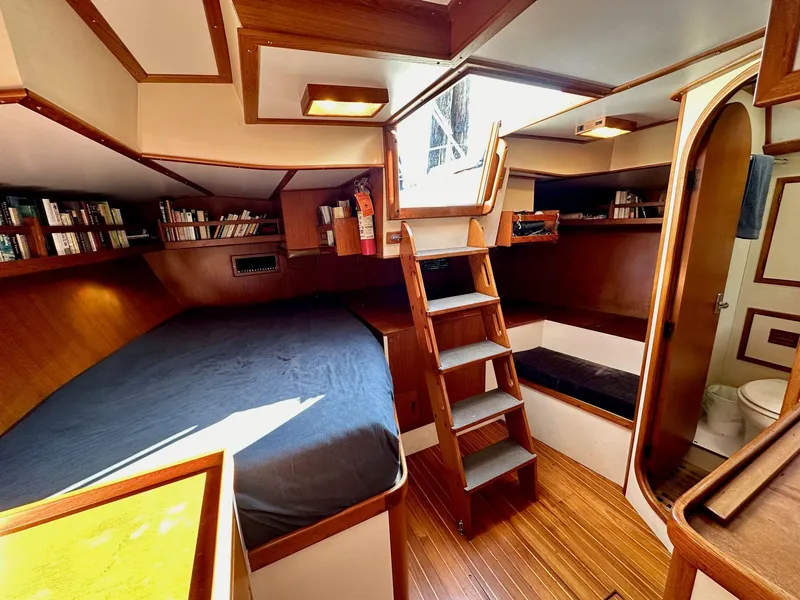 Slide: The Image of 1986 Cheoy Lee Pedrick 55 Sloop interior with wooden finish, bed, and stairs. - 6