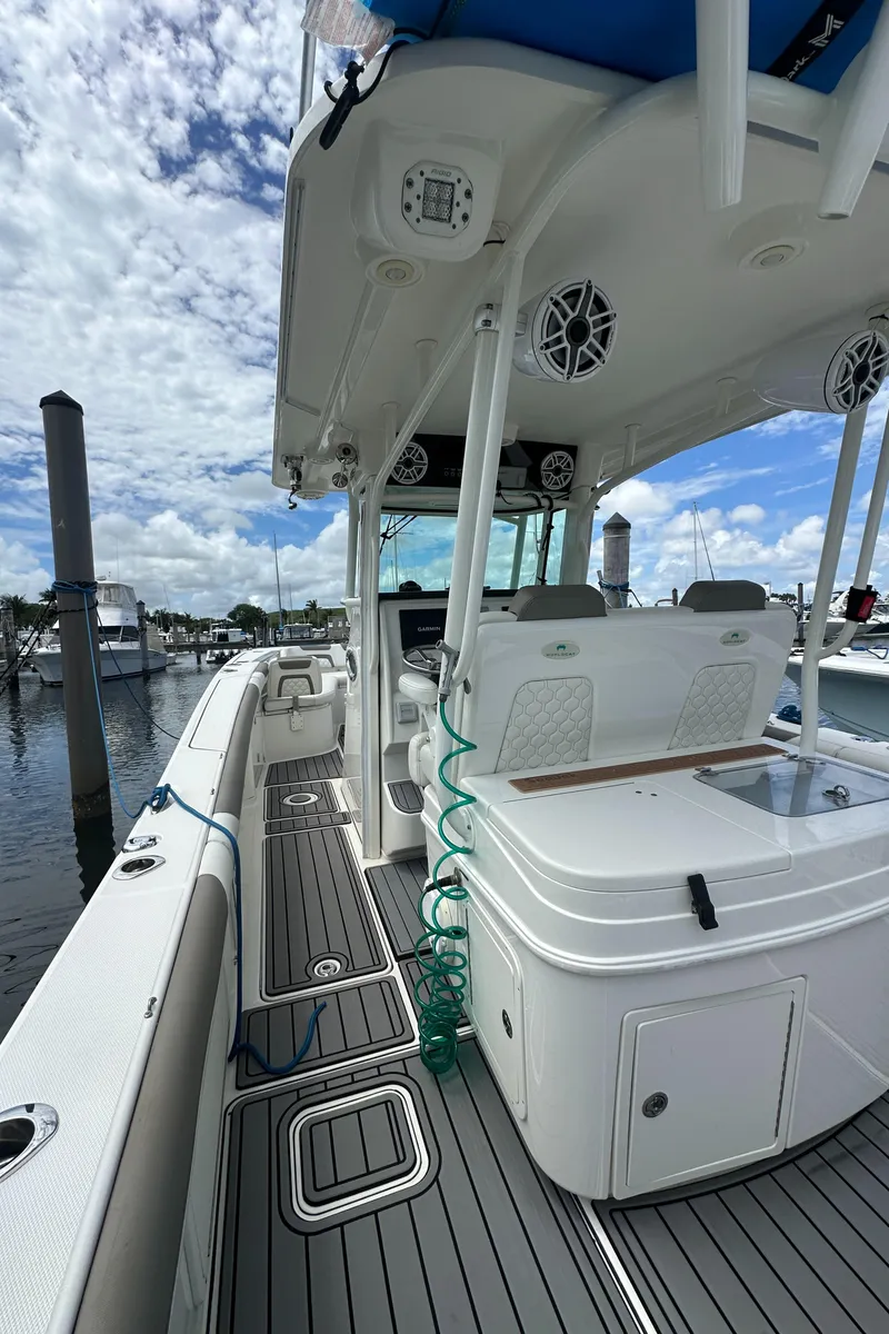 Slide: The Image of 2020 World Cat 325 CC boat docked, featuring spacious deck and modern amenities. - 12