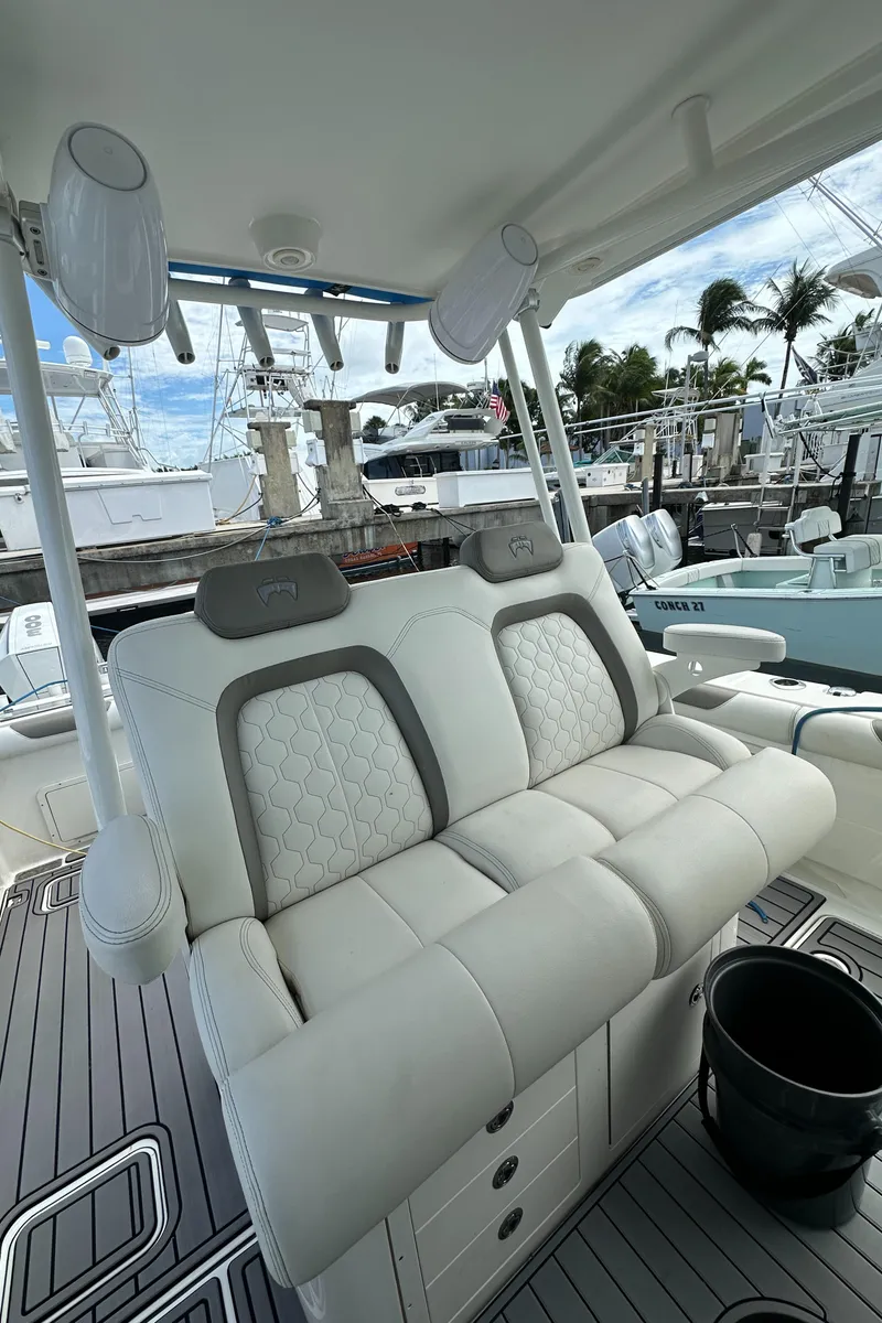 Slide: The Image of 2020 World Cat 325 CC boat interior with plush seating at marina. - 13